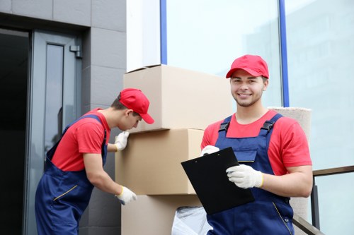 Removal team loading furniture into a moving van
